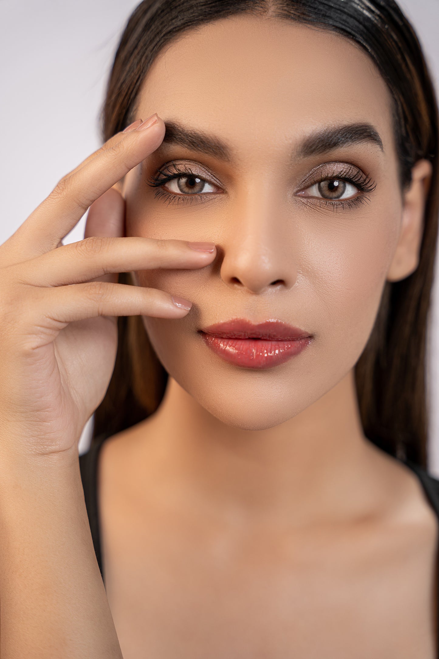 close up of model wearing brown lip gloss by zahra naveed